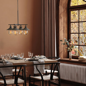 4 light Hardin hooded chandelier hanging above a dining room table..