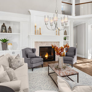 5 light Ribble valley chandelier with clear ribbed shades hanging above a coffee table in a living room.