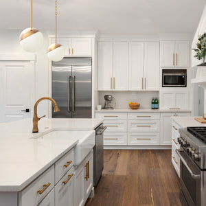 2 Brushed gold Milan pendant lights above a kitchen island. 