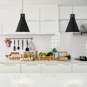 2 Conic black cone pendant lights hanging above kitchen island..