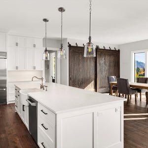 3 Barn Light pendant lights above a kitchen island.