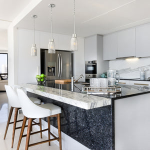 3 Ribble Valley pendant lights hung above a kitchen island.