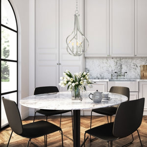 3-light Alloy Ribbons Candle style Chandelier in brushed nickell in a modern kitchen, hung over a dining table.