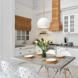 Tivoli matte white dome pendant in a modern kitchen above a table.