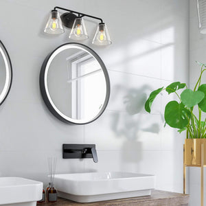 Regis vanity light in matte black with clear shade in a modern bathroom..