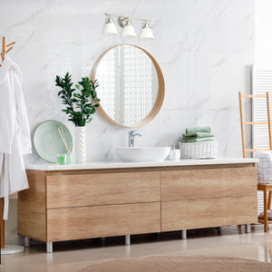 Tula vanity light in antique polished nickel finished with etched shades above a modern vanity in a bathroom...